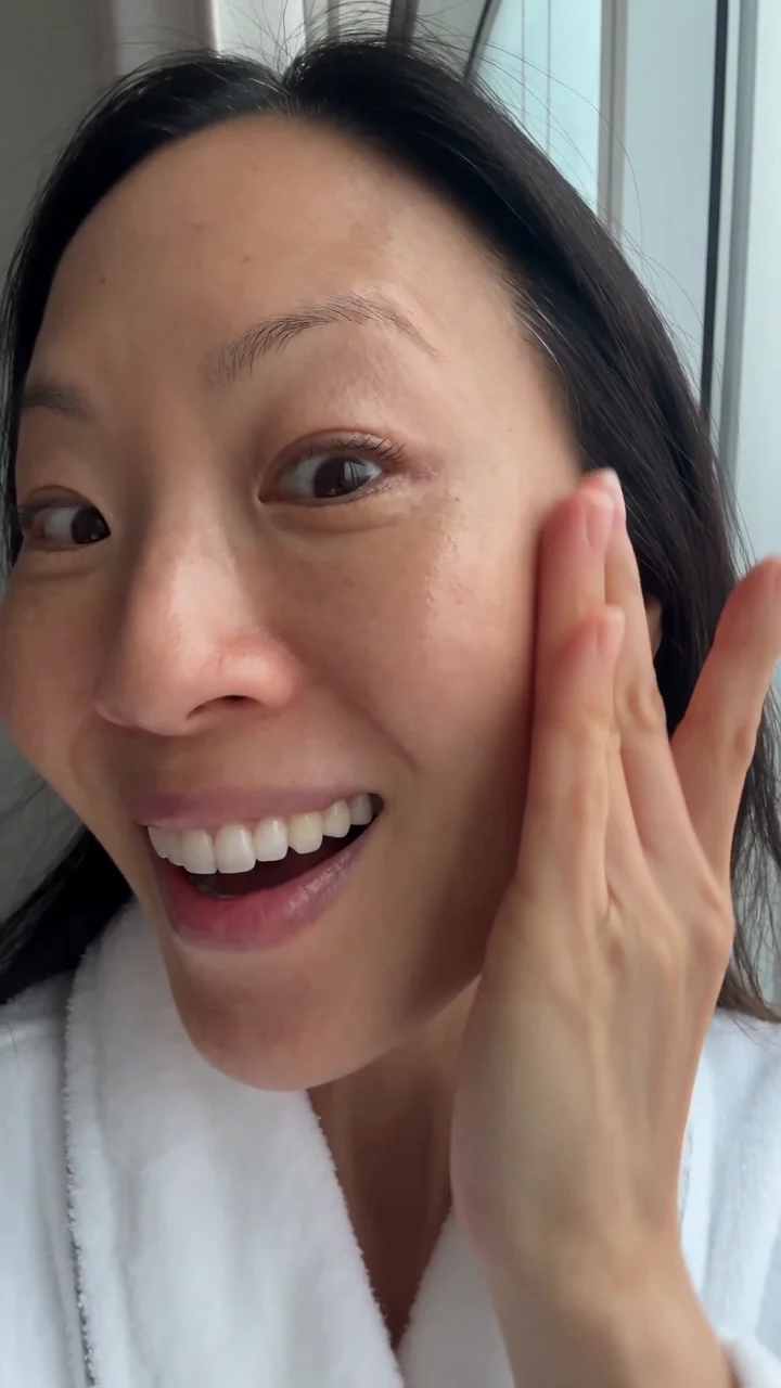 AI-generated woman holding a product to camera, indistinguishable from a phone selfie